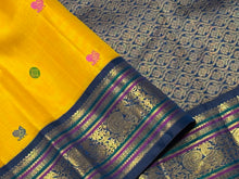 Vaibhogam-Gorgeous Yellow with Deep Sapphire Blue Handwoven Pure Jari Korvai Kanjivaram Silk with Pattu Buttas Woven Body with Rich and Intricate Meenakari work Borders Gorgeous Pallu and Contrast Woven Blouse