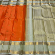 Vaibhogam-Gorgeous Orange with Elaichi Green Handwoven Pure Jari Korvai Kanjivaram Silk with beautiful buttas woven body with rich rudrakshas and jari lines striped borders gorgeous pallu and contrast woven blouse