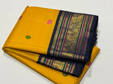 Vaibhogam-Gorgeous Yellow with Deep Sapphire Blue Handwoven Pure Jari Korvai Kanjivaram Silk with Pattu Buttas Woven Body with Rich and Intricate Meenakari work Borders Gorgeous Pallu and Contrast Woven Blouse