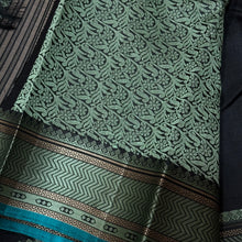 Mindblowing Black with Teal Handwoven Pure Zariless Kanjivaram Silk with intricately woven self Muthukattam body checks rich borders gorgeous pallu and Jacquard blouse beauty