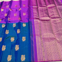 Saranga-Stunning Peacock Blue with Vadamalli Purple Handwoven Pure Jari Kanjivaram Silk in a half and half style woven body with muthukattam vertical stripes running thru the body with peacocks woven body rich pallu and contrast woven blouse.