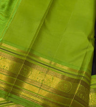 Vaibhogam- Gorgeous Deep Blackish Kanchana Brown with Parrot Green Handwoven Pure Jari Korvai with Buttas Kanjivaram Silk with beautiful double peacock motifs woven in a clover shaped motif with rich borders pallu and contrast woven blouse