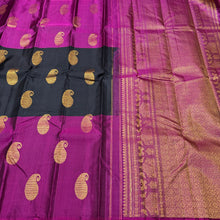 Saranga-Gorgeous Mubbakam Style Handwoven PureKanjivaram Silk in a beautiful black and deep magenta combination with middle portion in black and eithersides in deep magenta color with muthukattam striped body with paisleys woven with rich pallu and blouse