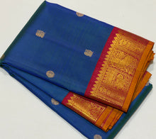 Vaibhogam- Gorgeous Peacock Blue with Deep Arakku Red  Handwoven Pure 2g Jari Korvai with Buttas Kanjivaram Silk with rich borders gorgeous pallu and contrast woven blouse