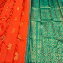 Saranga- Stunning Orange with Emerald Green Muthukattam with Peacock on a paisley motifs woven beautiful body rich and finely woven pallu and contrast emerald green blouse