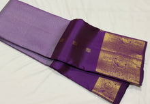 Vaibhogam- Mesmerizing Lavendar with Purple Handwoven Pure 2g Jari KanjivaramSilk with Jarioosi checked body with beautiful mayil chakram motifs woven middle borders with beautiful long and short borders pallu and contrast woven blouse