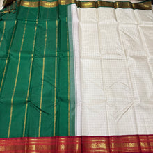 Offwhite with Arakku Red and Emerald Green Ganga Jamuna Korvai Borders with Plus buttas in silk threads woven all over the body with rich arakku pallu and simple green pallu on the other side which can be worn on either sides with a single arakku blouse