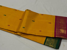 Vaibhogam- Gorgeous Mustard with Magenta and Bottle Green Handwoven Pure Jari Korvai Kanjivaram Silk with thread buttas woven body with beautiful ganga jamuna borders rich pallu and contrast woven blouse