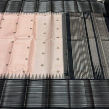 Saraswati-Gorgeous Handwoven Pure Zariless Korvai Kanjivaram Silk in a beautiful and rare peachish sandal shade with Black combination with beautiful kasuti style buttas woven beautiful body with varisaipet borders rich pallu and contrast woven blouse