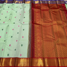 Vaibhogam- Gorgeous Pista Green with Violetish blue and Burgundy Maroon Handwoven Pure 2g Jari Korvai Kanjivaram Silk with Pattu Buttas woven body rich borders ganga Jamuna beautiful pallu and contrast woven blouse