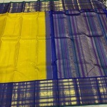Vaibhogam- Stunning Yellow with Royal Blue Handwoven Pure Zari Korvai Kanjivaram Silk with Buttas Rich Varisaipet Borders gorgeous Meenakari work Pallu and Contrast woven blouse