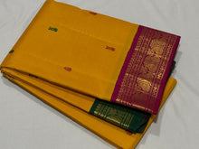 Vaibhogam- Gorgeous Mustard with Magenta and Bottle Green Handwoven Pure Jari Korvai Kanjivaram Silk with thread buttas woven body with beautiful ganga jamuna borders rich pallu and contrast woven blouse