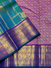 Vaibhogam-Gorgeous Peacock Green with Purple Handwoven Pure Jari Kanjivaram Silk with beautiful Jari checks with elephants and annapakshis woven body with rich borders pallu and contrast jari checked blouse
