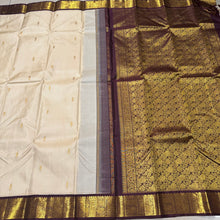 Offwhite with Coffee Brown Handwoven Pure Jari Korvai Kanjivaram Silk Saree with rich beautiful yazhis and peacocks woven borders rich pallu and contrast woven blouse