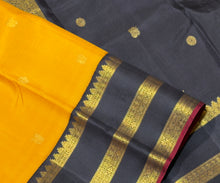 Vaibhogam- Stunning Yellow with Black Handwoven Pure 2g Jari Korvai with Buttas Kanjivaram Silk with beautiful triplepet borders with maroonish red selvedges rich pallu and a beautiful contrast black blouse