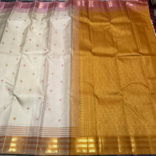 Sahana- Mesmerizing Offwhite with Golden Mustard and Pink handwoven Pure Jari Kanjivaram Silk with beautiful silk buttas woven body with Ganga Jamuna striped jari and silk threads woven beautiful borders rich pallu and contrast woven blouse
