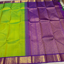 Sarasangi- Gorgeous Parrot Green with Violetish Purple Handwoven Pure 2g Jari Korvai Kanjivaram Silk with beautiful double peacocks woven borders rich pallu and contrast woven blouse