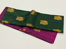 Saranga- Super Gorgeous Bottle Green with Deep Magenta Handwoven Pure Kanjivaram Silk woven in half and half style with muthukattam vertical stripes running vertically all over the body with peacocks woven body rich pallu and contrast woven blouse