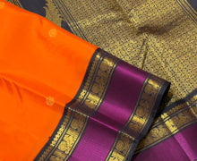 Vaibhogam- Stunning Fanta Orange with Kanchana Black Handwoven Pure Jari Korvai Kanjivaram Silk with beautiful buttas woven body with intricate doublepet with middle silk thread woven borders gorgeous kalakshetra parrots woven pallu and contrast blouse