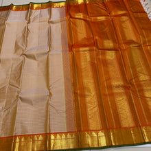 Sahana- Beautiful Biscuit beige with Orange Handwoven Pure Jari Kanjivaram Silk with muthukattam woven body with bawanchi temples and zigzags woven borders with green selvedges rich seer pallu and contrast orange blouse.