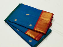 Vaibhogam- Stunning Peacock Blue with Dark Red Handwoven Pure Jari Korvai Kanjivaram Silk with Mayil Kuyil Buttas Woven beautiful body with rich borders veey uniquely woven pallu with elephants flying horses peacocks and contrast woven blouse