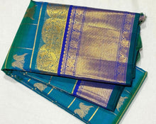 Vaibhogam-Gorgeous Peacock Blue Green with Royal Blue Handwoven Pure Jari Kanjivaram Silk Saree with Rettaikili motifs in Jari Checked body rich borders Pallu and Contrast woven blouse