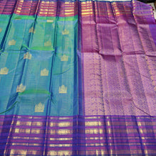 Vaibhogam- Gorgeous Peacock Bluish Green with Purple Handwoven Pure Jari Kanjivaram Silk in Vairaoosi with Buttas woven beautiful body with varisaipet borders rich pallu and contrast purple vairaoosi blouse