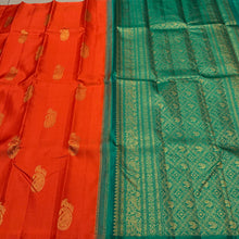 Saranga- Stunning Orange with Emerald Green Muthukattam with Peacock on a paisley motifs woven beautiful body rich and finely woven pallu and contrast emerald green blouse