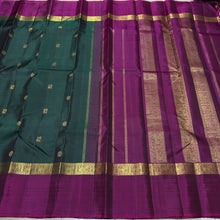 Sahana- Stunning Bottle Green with Dark Magenta Mayil Chakram Buttas Handwoven Pure 2g Jari Kanjivaram Silk with Spaced borders rich pallu and contrast woven blouse