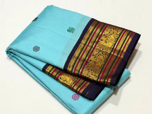 Vaibhogam- Gorgeous Powder Blue with Deep Blue Handwoven Pure Jari Korvai Kanjivaram Silk with gorgeous pattu buttas woven body rich meenakari silk thread and zari woven beautiful borders rich pallu with very intricate and contrast woven beautiful blouse