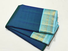 Sarasangi-Gorgeous Deep Peacock Blue with Soft Baby Blue Combination in a Handwoven Pure Jari Korvai Kanjivaram Silk with beautiful borders rich seer pallu and contrast woven blouse
