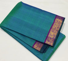 Nayaki- Gorgeous Peacock Bluish Green with Purple with Small borders Handwoven Pure Jari Kanjivaram Silk with rich seer pallu and contrast woven purple blouse