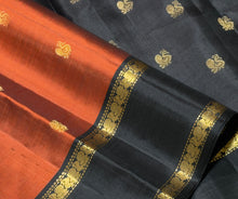 Sahana- Stunning Rust with Black Buttas Handwoven Pure Kanjivaram Silk with beautiful buttas woven body with doublepet borders rich buttas woven pallu and contrast woven blouse