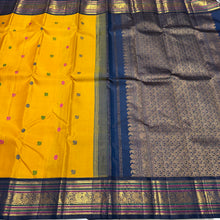 Vaibhogam-Gorgeous Yellow with Deep Sapphire Blue Handwoven Pure Jari Korvai Kanjivaram Silk with Pattu Buttas Woven Body with Rich and Intricate Meenakari work Borders Gorgeous Pallu and Contrast Woven Blouse