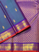Sahana- Gorgeous Dual tone Lavendarish Blue with Purple Small Borders with orange selvedges with Buttas Handwoven Pure Jari Kanjivaram Silk with rich pallu and contrast woven blouse