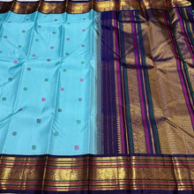 Vaibhogam- Gorgeous Powder Blue with Deep Blue Handwoven Pure Jari Korvai Kanjivaram Silk with gorgeous pattu buttas woven body rich meenakari silk thread and zari woven beautiful borders rich pallu with very intricate and contrast woven beautiful blouse