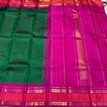 Sarasangi-Stunning Bottle Green with Rani Pink Handwoven Pure Jari Korvai Kanjivaram Silk with Fishpet Borders with temples woven with rich seer pallu and contrast woven blouse.