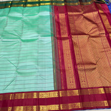 Vaibhogam- Gorgeous Pastel Green with Ganga Jamuna Bottle Green and Arakku Red borders with Neli Veldhari woven beautiful body with fishpet double borders rich pallu and contrast woven blouse