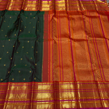 Vaibhogam- Gorgeous Bottle Green with Orange Handwoven Pure Jari Korvai Kanjivaram Silk with beautiful buttas woven body with rich varisaipet borders beautiful pallu and contrast woven blouse with Pink  selvedges