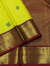 Vaibhogam- Stunning Lemoney Green tinted Yellow with Burgundy Maroon in a Handwoven Pure Jari Korvai Kanjivaram Silk with beautiful pattu buttas woven body rich borders gorgeous pallu and contrast woven blouse