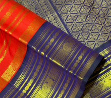 Vaibhogam- Gorgeous Red with Deep Blue Handwoven Pure 2g Jari Kanjivaram Silk with beautiful Jari veldhari striped body with different patterns rich varisaipet borders gorgeous pallu and contrast deep blue jari woven blouse