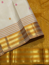 Sahana- Mesmerizing Offwhite with Golden Mustard and Pink handwoven Pure Jari Kanjivaram Silk with beautiful silk buttas woven body with Ganga Jamuna striped jari and silk threads woven beautiful borders rich pallu and contrast woven blouse