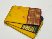 Vaibhogam -Stunning Yellow with Burgundy and BottleGreen Handwoven Pure Jari Korvai Kanjivaram Silk with silk buttas woven beautiful body with rich Gandaberundas woven ganga jamuna borders on both sides with rich pallu and contrast blouse