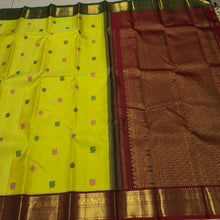 Vaibhogam- Stunning Lemoney Green tinted Yellow with Burgundy Maroon in a Handwoven Pure Jari Korvai Kanjivaram Silk with beautiful pattu buttas woven body rich borders gorgeous pallu and contrast woven blouse