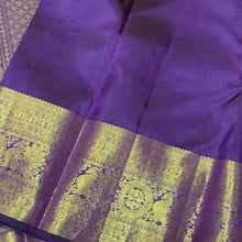 Vaibhogam- Mesmerizing Lavendar with Purple Handwoven Pure 2g Jari KanjivaramSilk with Jarioosi checked body with beautiful mayil chakram motifs woven middle borders with beautiful long and short borders pallu and contrast woven blouse