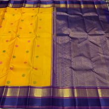 Vaibhogam- Gorgeous Yellow with Blue Handwoven Pure 2gJari Korvai Kanjivaram Silk with beautiful gandaberundas woven silk buttas in body with beautiful spaced meenakari woven borders rich pallu and contrast woven blouse