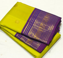 Vaibhogam-Mesmerizing Green Sampanga with Purple Handwoven Pure Jari Korvai Kanjivaram Silk with beautiful mayil chakram buttas woven body with rich gettipet borders rich pallu and contrast woven beautiful blouse