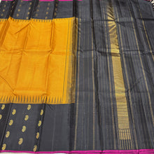 Gorgeous Mustard with Black Podikattam Checked Body with Beautiful Paisleys and small temples woven double side borders with dark Magenta Selvedges with Rich Seepu Seer Pallu and Contrast woven blouse