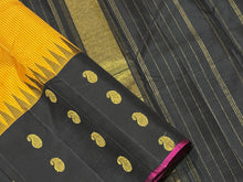 Gorgeous Mustard with Black Podikattam Checked Body with Beautiful Paisleys and small temples woven double side borders with dark Magenta Selvedges with Rich Seepu Seer Pallu and Contrast woven blouse