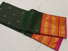 Vaibhogam- Gorgeous Bottle Green with Orange Handwoven Pure Jari Korvai Kanjivaram Silk with beautiful buttas woven body with rich varisaipet borders beautiful pallu and contrast woven blouse with Pink  selvedges